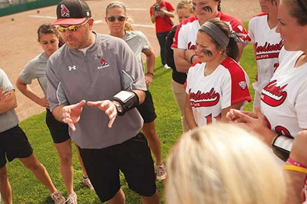 Head softball coach Craig Nicholson speaks to the softball team after their win against Buffalo. The win made them the No. 1 seed in the MAC tournament that took place last weekend. DN FILE PHOTO JORDAN HUFFER