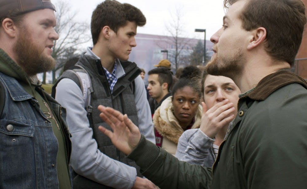 Wes Guthrie (left), a senior computer science major and Donald Trump supporter, argues with a Trump protestor after resistence rally to protest President Donald Trump on Jan. 20. The argument stayed peaceful, but went on for long after the rally finished. Kara Berg // DN