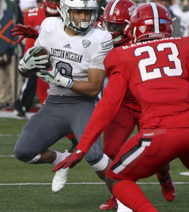 Eastern Michigan's Line Latu tries to dodge Ball State sophomore safety Brett Anderson II during the Cardinals' game against the Eagles Oct. 20, 2018, at Scheumann Stadium. Ball State lost 42-20 on Homecoming. Paige Grider, DN