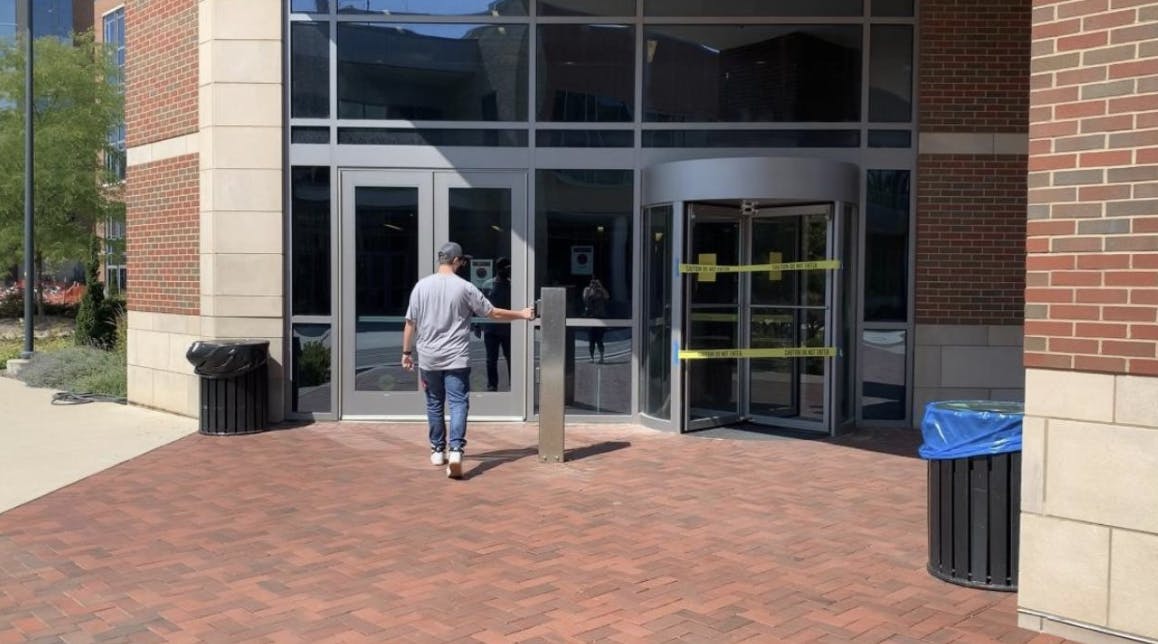 Ball State freshman Colin Williams keying into residence hall Johnson A after the Housing and Residence Life Office sent an email to students stating that they must swipe their ID before they enter the hall.