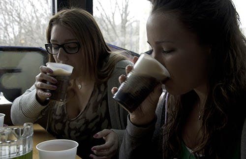Kate McDonald and Kristin Michels chug Irish car bombs at The Locker Room on early March 17, 2013. To kick start St. Patrick’s Day the girls shared a round of screw drivers, Irish car bombs and pitchers of green beer. DN PHOTO RJ RICKER
