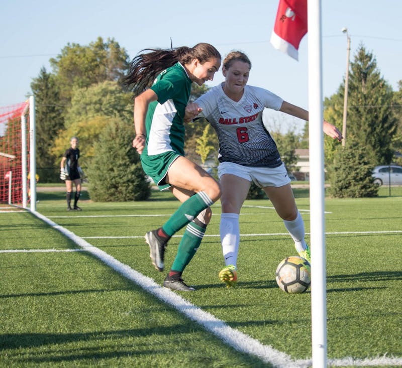 Senior midfielder Lucy Walton pushes against an Eastern Michigan University player a on Oct. 13 at Briner Sports Complex. Rebecca Slezak, DN