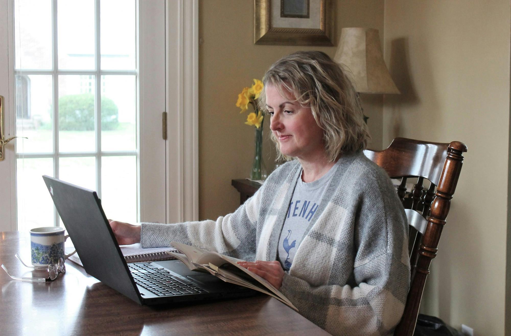 Pamela Hartman, associate professor of English, works on her laptop April 10, 2020, at her home. While there are some positives to online instruction, Hartman said it doesn't outweigh the stress it has caused both her and her students. Pamela Hartman, Photo Provided