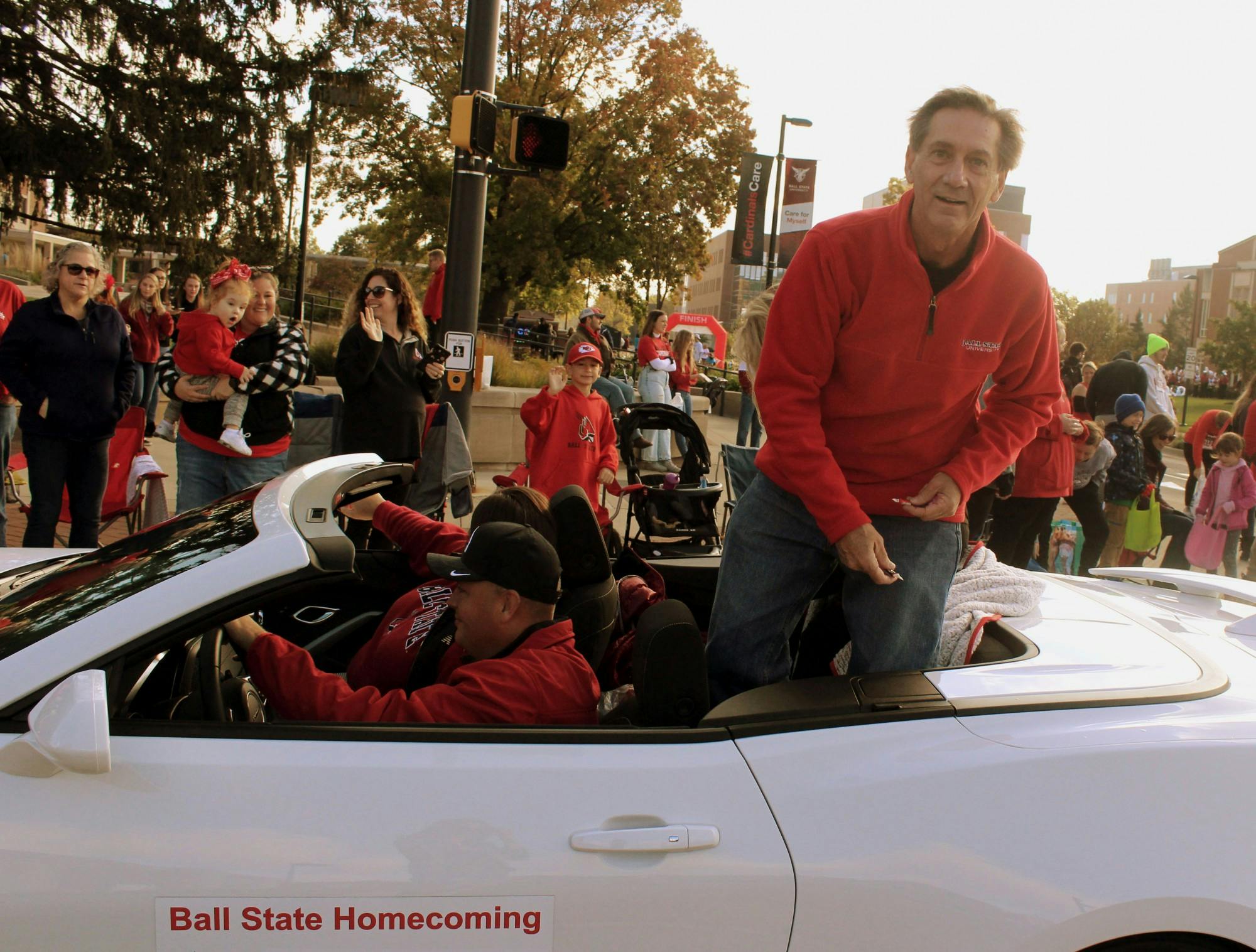 Mayor Dan Ridenour throws candy to parade watchers during the homecoming parade at the Scramble Light on Ball State's campus, Muncie, IN, on Saturday, Oct. 23, 2021. 