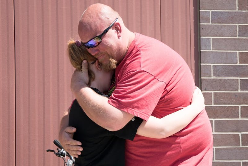 A parent sees his child for the first time after waiting for him to come out from Noblesville High School after being on lockdown due to a communicative threat and an active shooter at Noblesville West Middle School May 25, 2018. Stephanie Amador, DN File