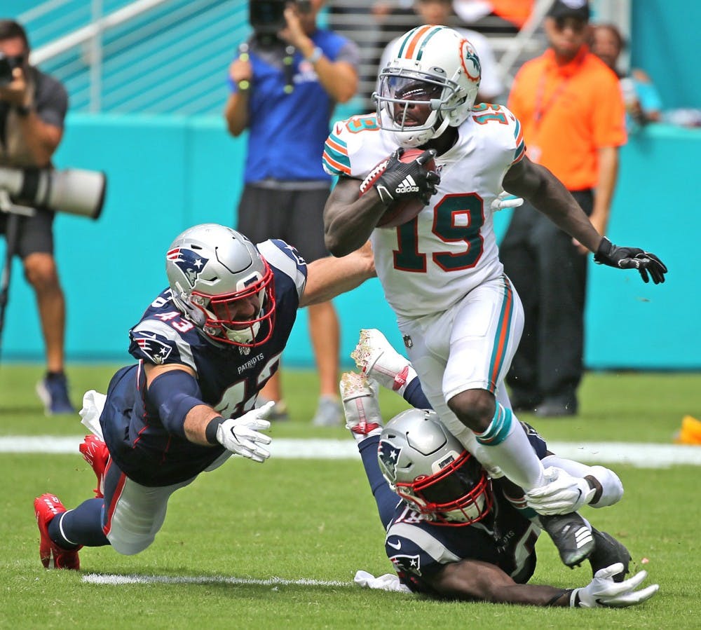 Miami Dolphins' Jakeem Grant (19) gets tackled by New England Patriots Nate Ebner (43) and Matthew Slater (18) in the fourth quarter on Sunday, Sept. 15 2019 at Hard Rock Stadium in Miami Gardens, Fla. (Charles Trainor Jr./Miami Herald/TNS)