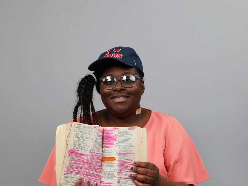 Ball State student Rayanna Herron holds up the Bible while posing for a photo March 1 at the Arts and Journalism Building. Mya Cataline, DN