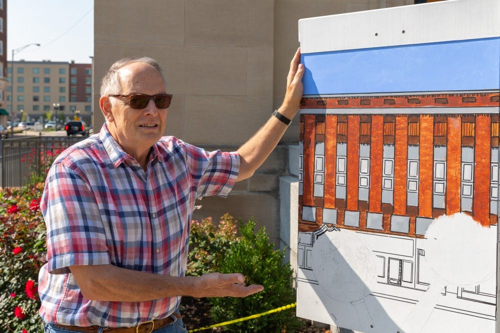 <p>Robert Hartley with his work in progress traffic box art on Wednesday Aug. 22, in Muncie, IN. Hartley’s traffic box can be found on the corner of West Charles Street and South High Street. <strong>Kyle Crawford, DN</strong></p>