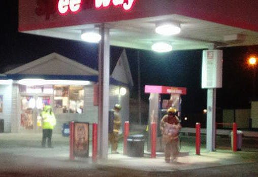 Firefighters use a quick-dry solution to cover a gasoline spill at the Speedway on the corner of S. Tillitson Ave. and W. Jackson Street. DN PHOTO COLIN GRYLLS