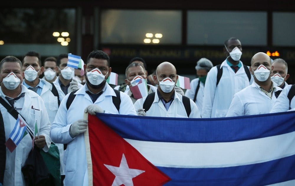 <p>Medics and paramedics from Cuba pose upon arrival at the Malpensa airport March 22, 2020, in Milan, Italy. 53 doctors and paramedics from Cuba arrived in Milan to help with coronavirus treatment in Crema. <strong>(AP Photo/Antonio Calanni)</strong></p>