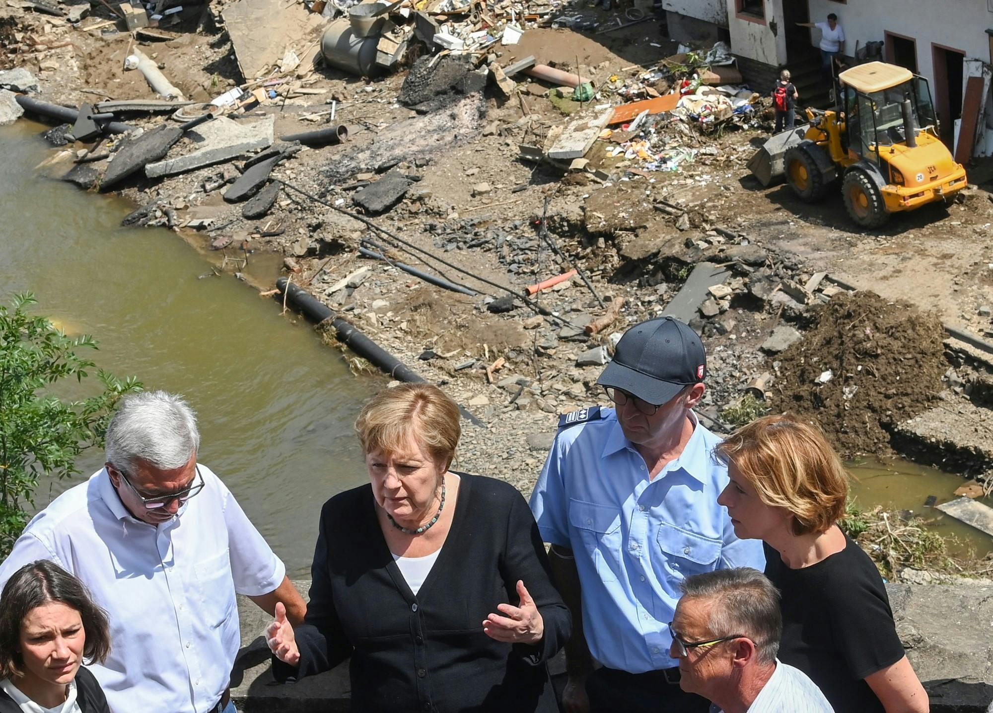 German Chancellor Angela Merkel (2ndL) and Rhineland-Palatinate State Premier Malu Dreyer (R) talk as they stand on a bridge during their visit in the flood-ravaged areas on July 18, 2021 in Schuld, near Bad Neuenahr-Ahrweiler, Rhineland-Palatinate state, western Germany. Extreme downpours caused devastating floods this week in Germany and other parts of western Europe devastating the region. The death toll across Germany and Belgium has risen to at least 180 as rescue workers continue their efforts and communities begin to clear the debris left by the receding waters. (Christof Stache-Pool/Getty Images/TNS)