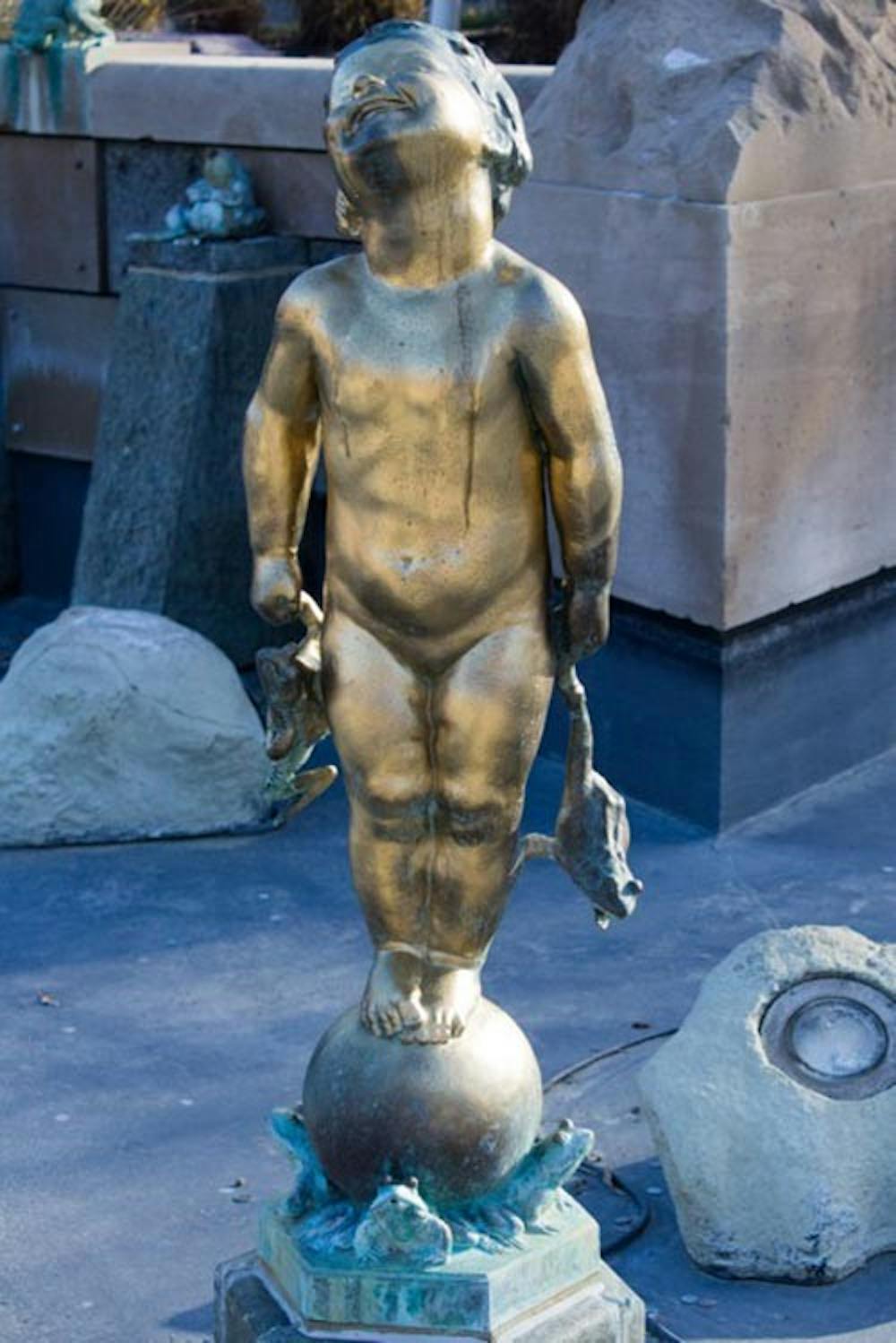Frog Baby sports a new coat of gold paint Dec. 14. The act of vandalism to the iconic statue has left some students outraged. DN FILE PHOTO TAYLOR IRBY