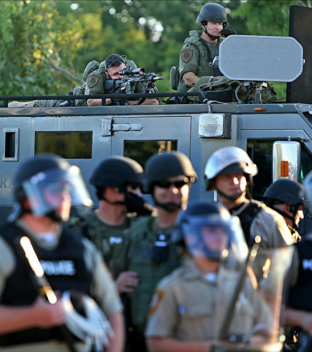 Police officers in military-style equipement along W. Florissant Avenue on Tuesday, Aug. 12, 2014, in Ferguson, Mo. (David Carson/St. Louis Post-Dispatch/TNS)