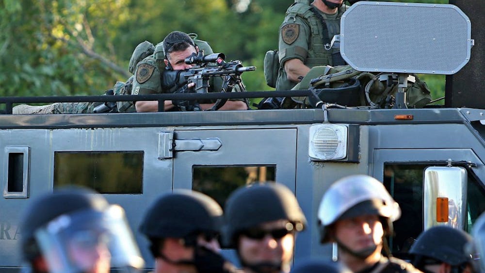 Police officers in military-style equipement along W. Florissant Avenue on Tuesday, Aug. 12, 2014, in Ferguson, Mo. (David Carson/St. Louis Post-Dispatch/TNS)