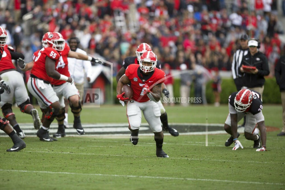 <p>Georgia running back D'Andre Swift (7) runs the ball in the first half of the NCAA football spring G-Day game at the University of Georgia in Athens, Ga., on Saturday, April 20, 2019. (Jenn Finch/Athens Banner-Herald via AP)</p>