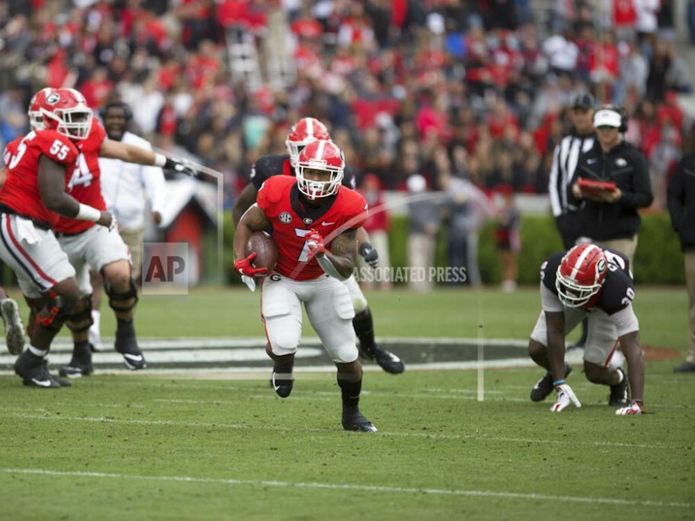 Georgia running back D'Andre Swift (7) runs the ball in the first half of the NCAA football spring G-Day game at the University of Georgia in Athens, Ga., on Saturday, April 20, 2019. (Jenn Finch/Athens Banner-Herald via AP)