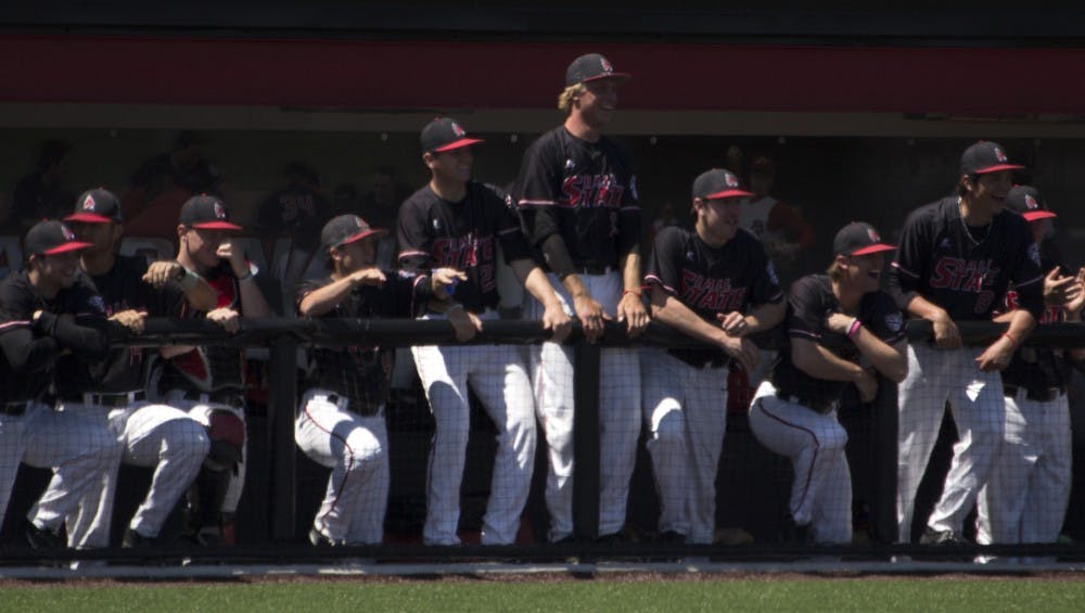 The Ball State baseball team celebrates after their teammate, Roman Baisa, makes it safely to third base in the game against Bowling Green on April 23. DN PHOTO GRACE RAMEY