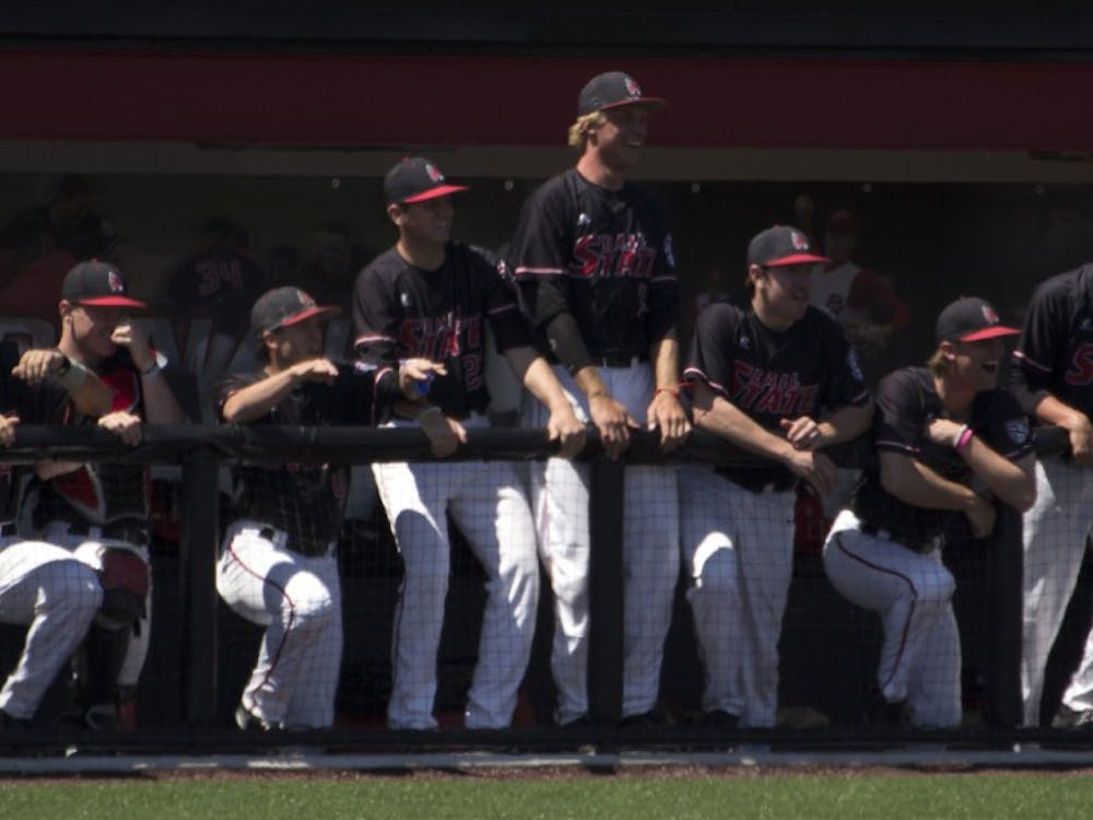 The Ball State baseball team celebrates after their teammate, Roman Baisa, makes it safely to third base in the game against Bowling Green on April 23. DN PHOTO GRACE RAMEY