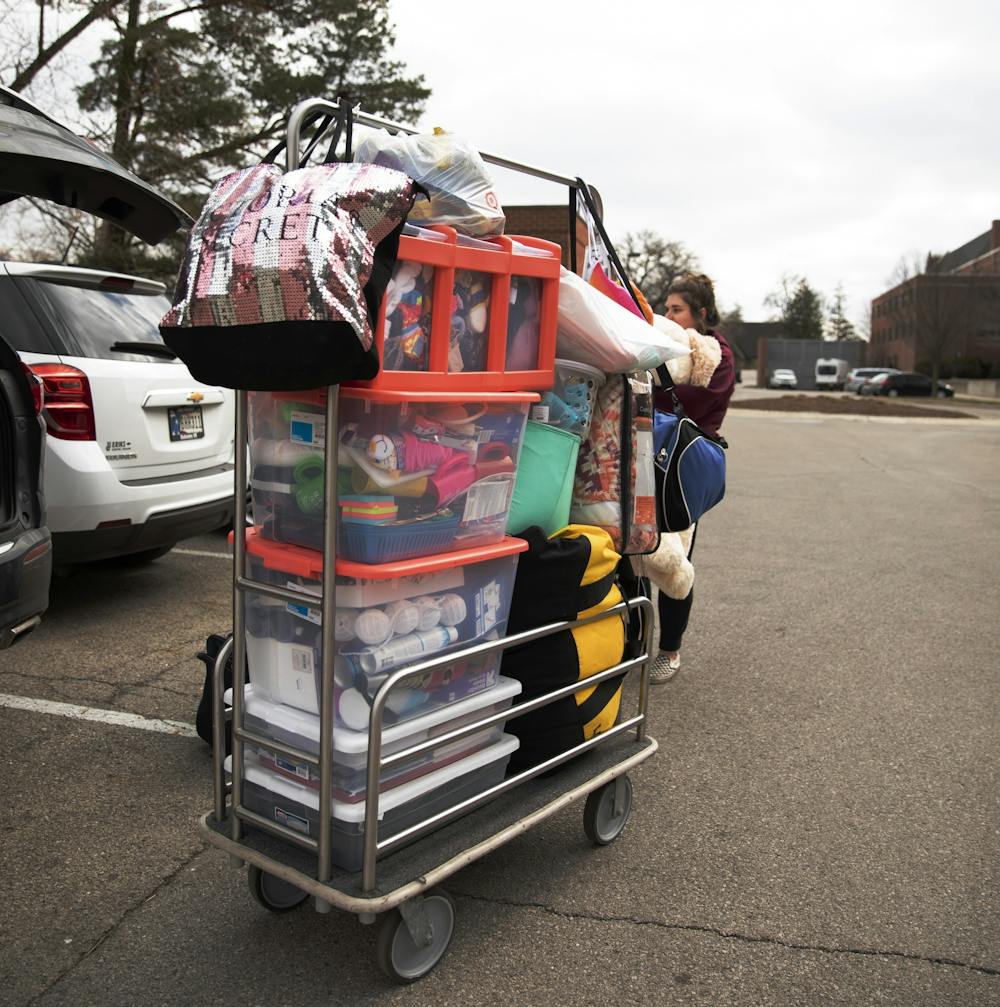 <p>Exercise science senior Danielle Sprouse moves out of her dorm March 18, 2020, outside of Park Hall. Students were told on March 16 the dorms would be closing by 5 p.m. March 29. <strong>Jacob Musselman, DN</strong></p>