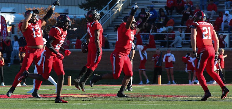 A group of Ball State football players celebrate an incomplete pass against Northern Illinois on Oct. 26 at Scheumann Stadium. Mallory Hall, DN