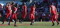 A group of Ball State football players celebrate an incomplete pass against Northern Illinois on Oct. 26 at Scheumann Stadium. Mallory Hall, DN