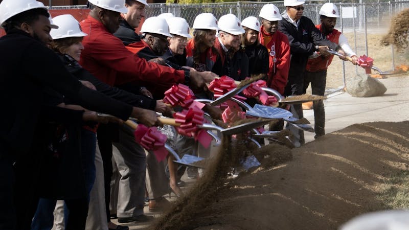 President Mearns, the Board of Trustees and several guests break ground on the new Multicultural Center. The new center, which will be finished in about a year, will a 10,000 square foot facility located to the east of Bracken Library. John Lynch, DN.