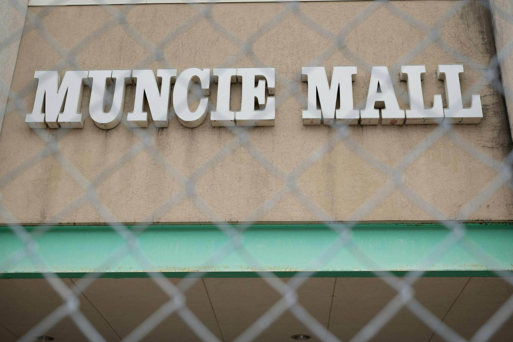 An entrance to the Muncie Mall blocked by fencing pictured March 17 in Muncie, Indiana. The mall is scheduled to be demolished in September. Ryan Fleek, DN