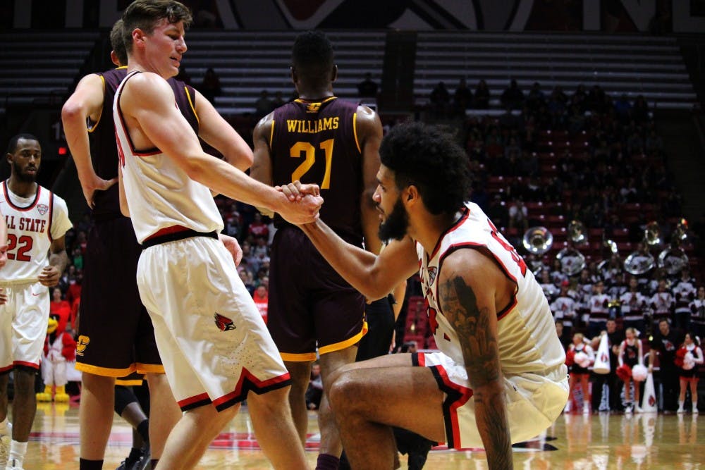 Ryan Weber helps teammate Trey Moses up after a fall in the game against Central Michigan in Worthen Arena on Jan. 17. Alicia M. Barnachea // DN. 