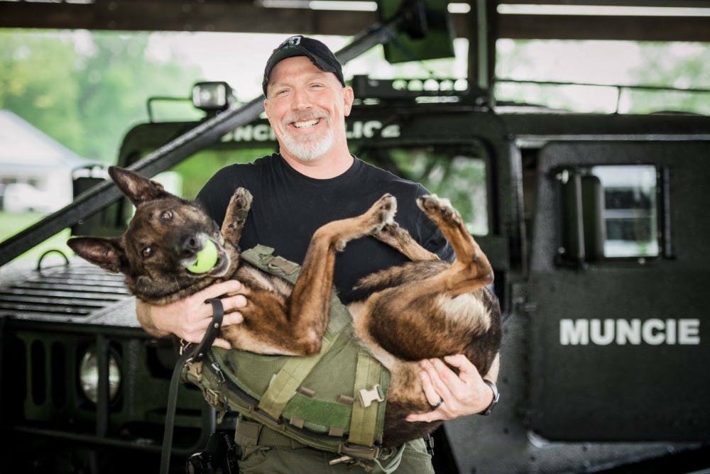 K-9 Carlos and his handler, Officer Wells pose for a photo in the Muncie Police Department 2017 calendar. Muncie Police Calendar Facebook, Photo Courtesy