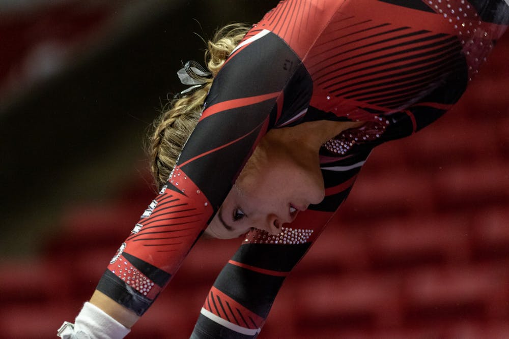 <p>A member of the Ball State Gymnastics team rotates during a transition as she competes in the uneven bars routine, Jan. 26, 2020 in John E. Worthen Arena. The Cardinals secured a win by putting up 194.2 points. <strong>Paul Kihn, DN</strong></p>