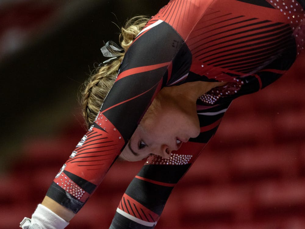 A member of the Ball State Gymnastics team rotates during a transition as she competes in the uneven bars routine, Jan. 26, 2020 in John E. Worthen Arena. The Cardinals secured a win by putting up 194.2 points. Paul Kihn, DN