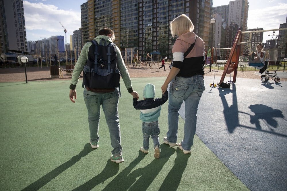 Irina and Anastasia Lagutenko walk with their son, Dorian, at a playground July 2, 2020, in St. Petersburg, Russia. Their 2017 wedding wasn’t legally recognized in Russia. (AP Photo)