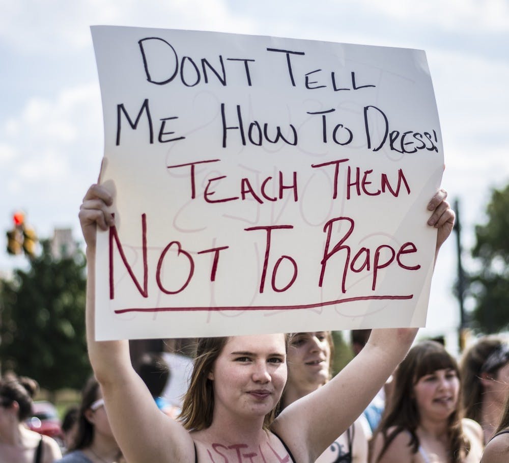 <p>A demonstrator holds a sign during the annual Slut Walk hosted by Feminists for Action and Alliance for Disability Awareness Sept. 23, 2016. The group has not hosted the event since the start of the COVID-19 pandemic in March 2020. <strong>Samantha Brammer, DN File</strong></p>