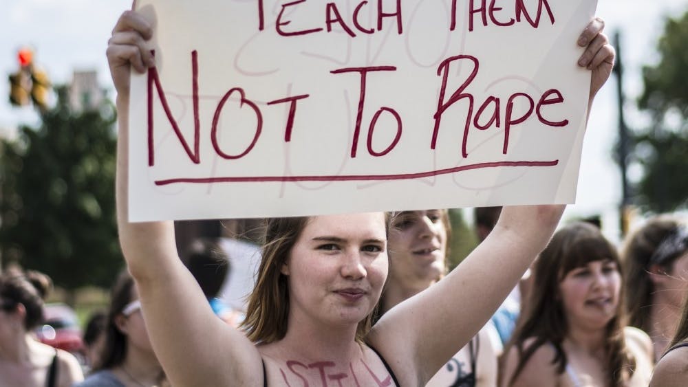 A demonstrator holds a sign during the annual Slut Walk hosted by Feminists for Action and Alliance for Disability Awareness Sept. 23, 2016. The group has not hosted the event since the start of the COVID-19 pandemic in March 2020. Samantha Brammer, DN File