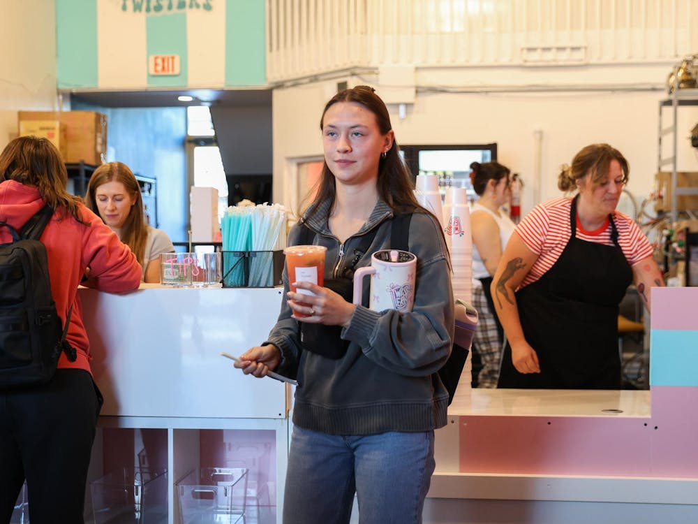 A patron of Twisters Soda bar walks out with a beverage Oct. 10 in The Village. Twisters had it's grand opening to the Ball State Campus. Andrew Berger, DN