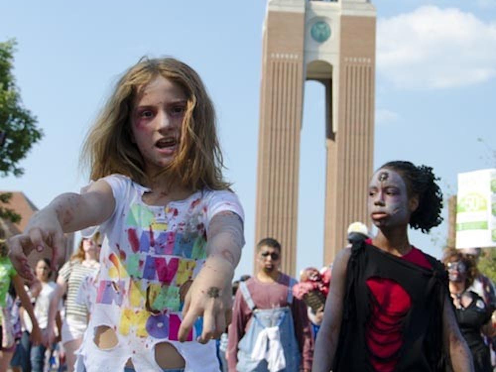 Willoe Cunnington walks with roughly 250 other zombies in a benefit walk for charity. DN FILE PHOTO COREY OHLENKAMP