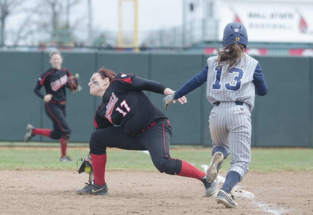 Senior Taylor Rager reaches for the ball to get a Toledo player out April 6 at the Ball State Softball Complex. DN PHOTO BREANNA DAUGHERTY