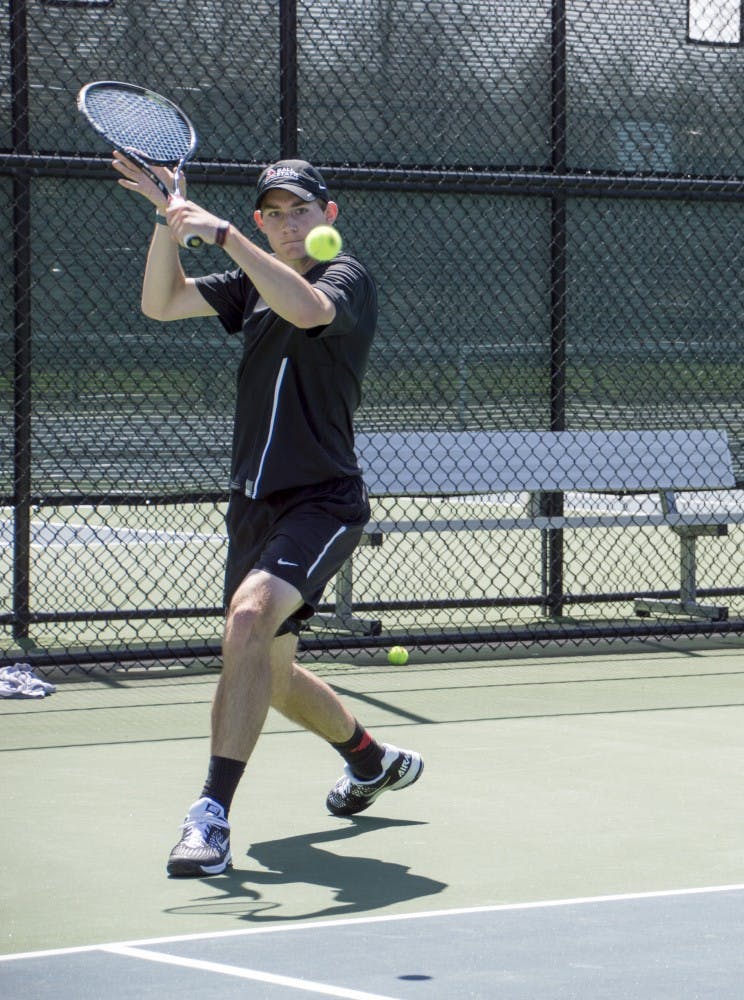 Senior Ray Leonard hits the ball during the match against Western Michigan on April 11 at Cardinal Creek Tennis Courts. DN PHOTO ALAINA JAYE HALSEY