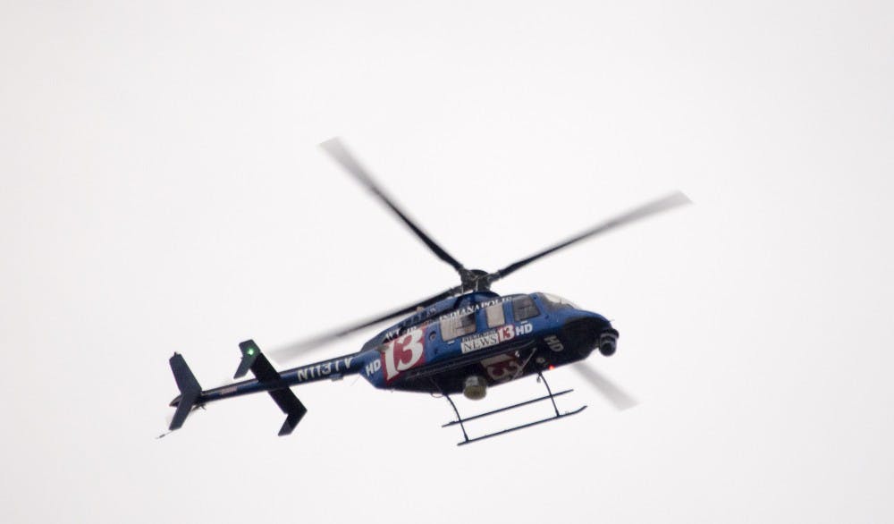 Television helicopters circle around the area as police secure the Student Recreation and Wellness Center after a report of an armed assailant in the building. DN PHOTO COREY OHLENKAMP