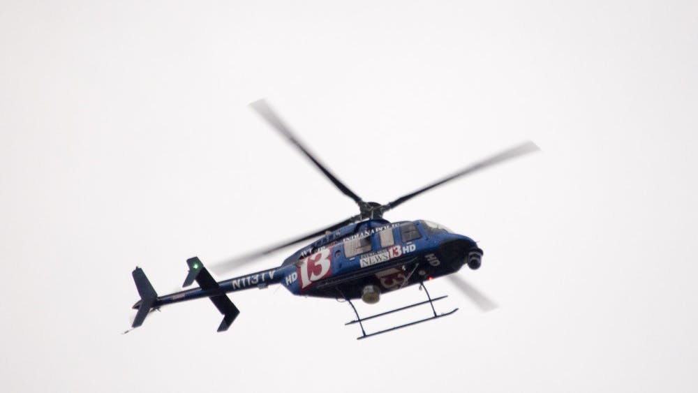 Television helicopters circle around the area as police secure the Student Recreation and Wellness Center after a report of an armed assailant in the building. DN PHOTO COREY OHLENKAMP