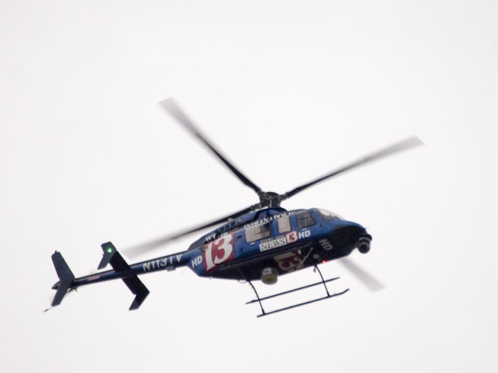 Television helicopters circle around the area as police secure the Student Recreation and Wellness Center after a report of an armed assailant in the building. DN PHOTO COREY OHLENKAMP