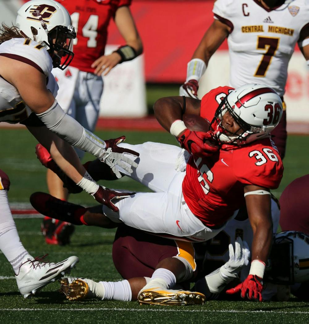 Freshman running back Caleb Huntley falls to the ground during the Cardinals’ game against Central Michigan on Oct. 21 at Scheumann Stadium. Huntley had 81 rushing yards for gain. Paige Grider, DN