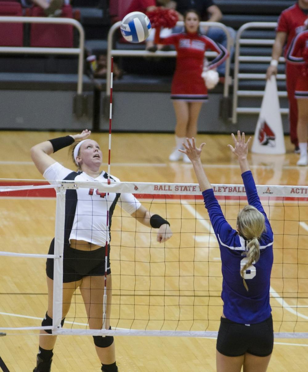 Redshirt middle blocker junior Kelly Hopkins attempts to hit the ball over the net during the match against Western Illinois on Aug. 29 at Worthen Arena. DN PHOTO BREANNA DAUGHERTY