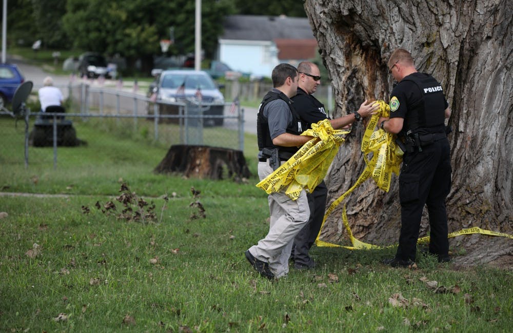 <p>Muncie Police Department officers take down police lines after a shooting at the intersection of Hartford and Princeton Street Friday, Aug. 23, 2019. <strong>Rebecca Slezak, DN</strong></p>