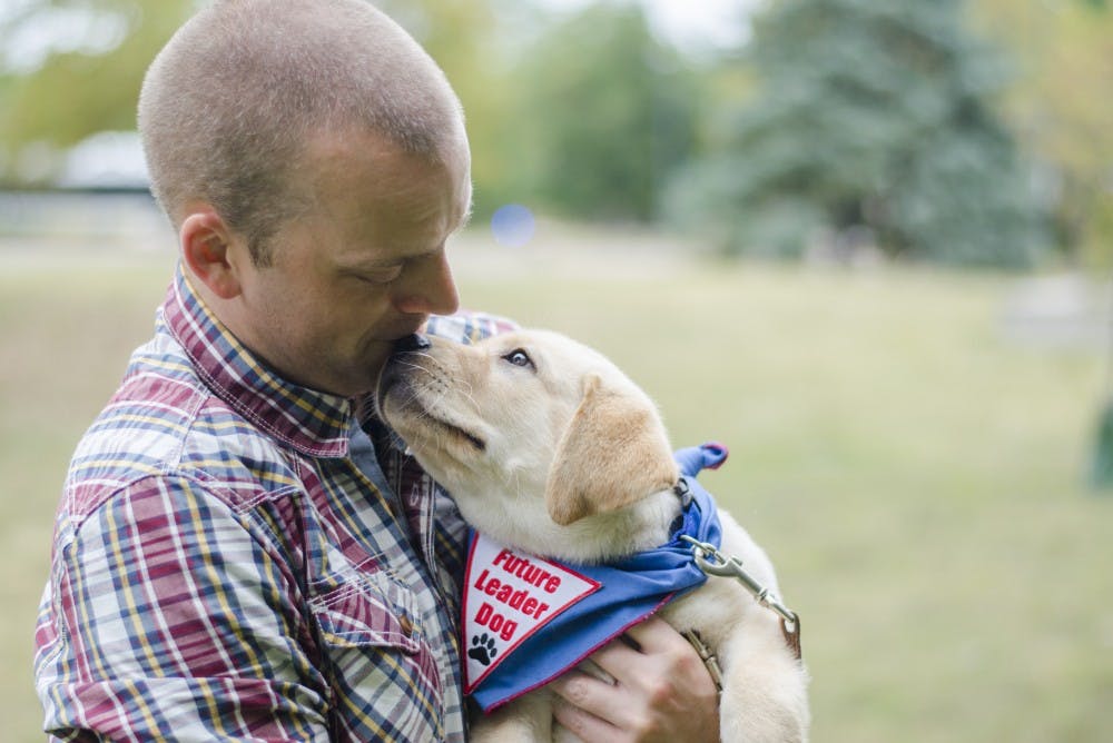 <p>When Charlie, a yellow Labrador retriever, returns to Rochester Hills, Michigan, on August 7, he will have visited 25 states alongside assistant professor of journalism Robin Blom.&nbsp;<em>DN FILE PHOTO BREANNA DAUGHERTY</em></p>