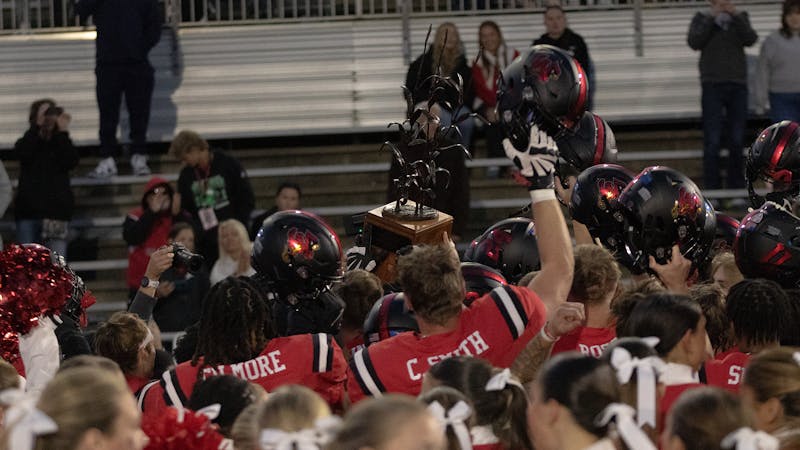 The Cardinals lift the trophy against Northern Illinois Oct. 26 at Scheumann Stadium. The Cardinals won the game 25-23. Jayce Blane, DN