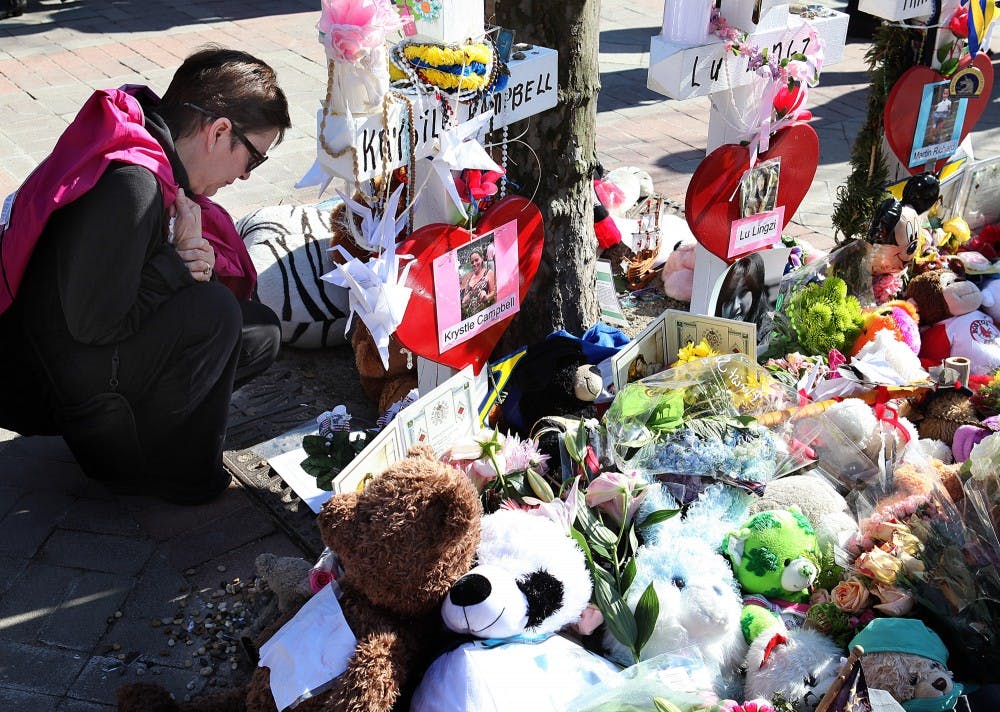 Joyce Schwartz pauses on April 25, 2013 at a memorial for Boston Marathon bombing victims at Copley Square in Boston. A year after the bombing, federal prosecuters believe they have a good amount of evidence to use against the surviving suspect. MCT PHOTO