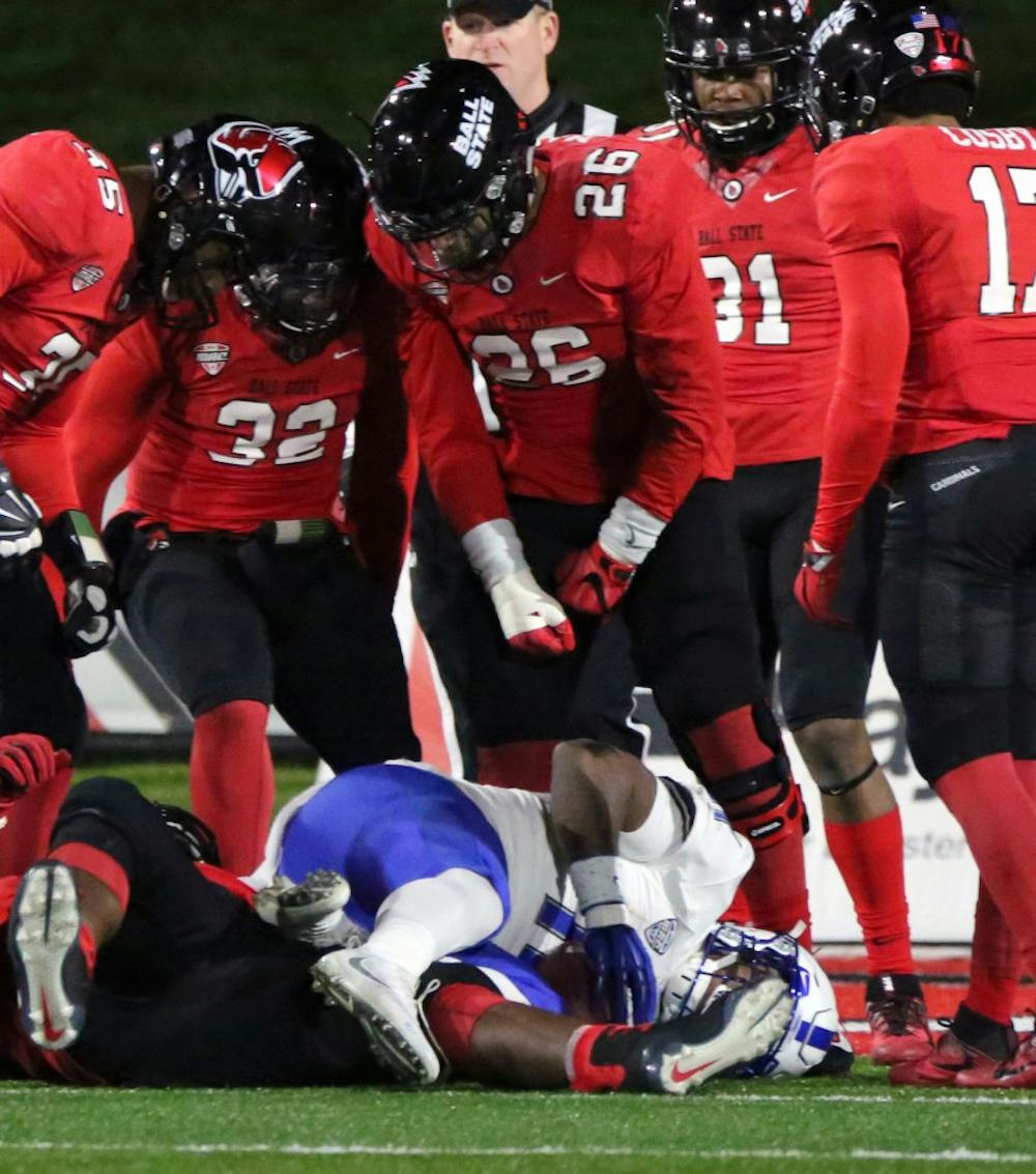 The Ball State defense loomes over Buffalo’s Theo Anderson after stopping him just short of a touchdown during the Cardinals’ game against the Bulls on Nov. 16 at Scheumann Stadium. Ball State lost 24 to 40. Paige Grider, DN