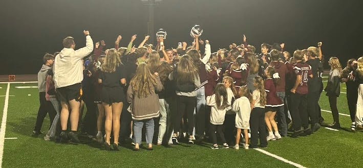 Wes-Del students rush the field and celebrate the homecoming win with the players. The Warriors improved to a 1-1 record.
