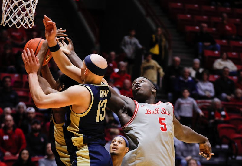 Ball State senior center Payton Sparks attempts to grab a rebound against Akron Feb. 25 at Worthen Arena. Sparks had three points for the Cardinals. Andrew Berger, DN 